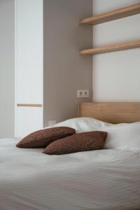 two pillows sitting on top of a bed at - Carijoca - Gemoderniseerd, lichtrijk & zijdelings zeezicht app in Koksijde