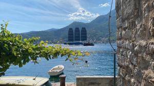 a view of a lake with a boat in the water at Oldhouse Vucinovic in Tivat