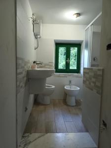 a bathroom with a sink and a toilet and a window at CASOLARE TROMBACCO in Vergemoli +28 photos