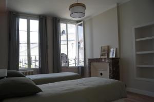 Postel nebo postele na pokoji v ubytování Appartement place du marché