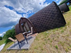 a sculpture of a house with a roof at Hobití chatka Lipno in Černá v Pošumaví