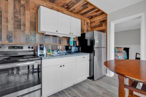 a kitchen with white cabinets and a table at Coconut Cay Resort in Marathon
