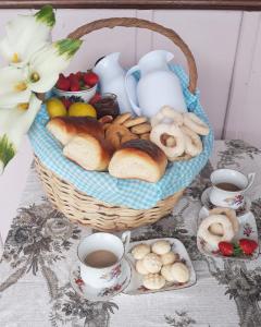 a basket of bread and tea on a table at Pousada São Matheus- Lauro Müller-SC in Louro Müller