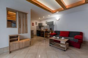 a living room with a red couch and a table at Domek Rodzinny na Roztoczu in Nowiny