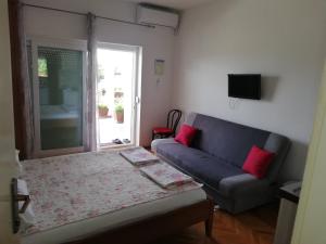 a living room with a couch and a table at Apartments Medici in Zaostrog