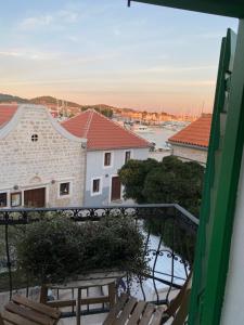 a balcony with a bench and a view of a harbor at Tribunj House in Tribunj +8 photos