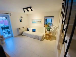 a bedroom with a white bed and a window at Tribunj House in Tribunj