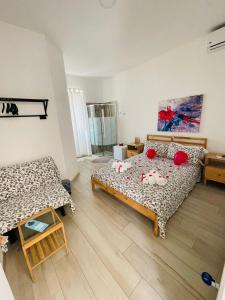 a bedroom with a bed and a couch in it at Il Daviduccio Suite in Siracusa