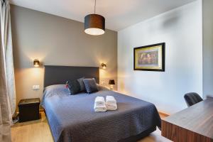 a bedroom with a bed with two pairs of shoes on it at Vila Vanesa with private pool near Rovinj - open 2022 in Rovinjsko Selo +42 photos