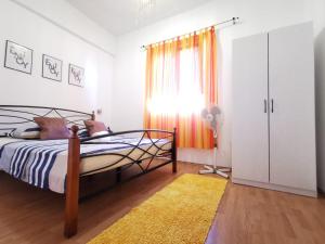 a bedroom with a bed and a window and a rug at Priska Apartment in Kaštela