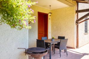 a table and chairs on the patio of a house at Agriturismo Il Poggiolo in Grosseto