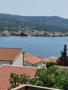 a view of a large body of water with houses at Apartments Matanovic in Rogoznica