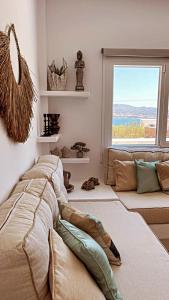 a bedroom with a bed and a large window at Voras Villa Panagia Beach in Antiparos