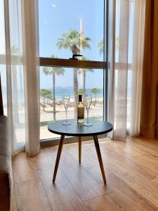 a table with a bottle of wine and two glasses at ELMAR HOTEL in Vlorë