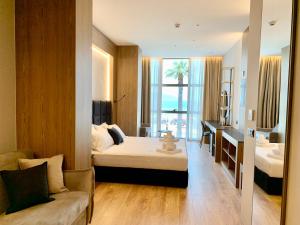 a bedroom with a bed and a desk and a couch at ELMAR HOTEL in Vlorë