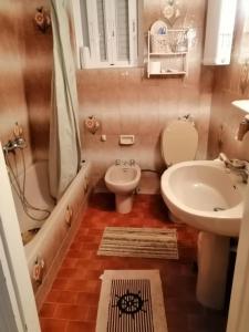 a small bathroom with a toilet and a sink at Cosmo luxury rooms in Monemvasia