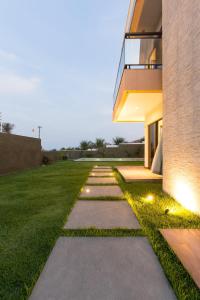 a walkway in front of a house with lights at LUXURIOUS NEW HOUSE, UNFORGETABLE EXPERIENCE. in Canoa Quebrada