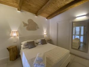 a bedroom with a bed with a fish on the wall at Koralline accommodation in Tropea