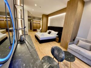 a hotel room with a bed and a couch at ELMAR HOTEL in Vlorë