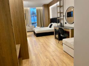 a hotel room with a bed and a mirror at ELMAR HOTEL in Vlorë