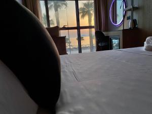 a bedroom with a bed with a view of the ocean at ELMAR HOTEL in Vlorë