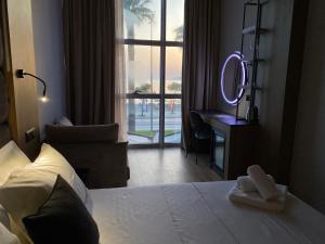 a hotel room with a bed and a mirror at ELMAR HOTEL in Vlorë