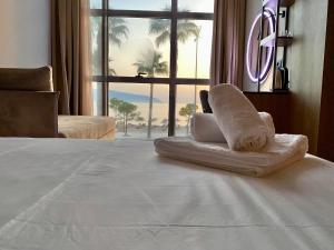 a hotel room with a pile of towels on a bed at ELMAR HOTEL in Vlorë