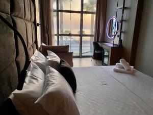 a bedroom with a large bed with a large window at ELMAR HOTEL in Vlorë