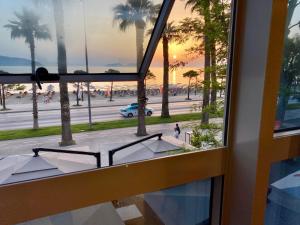 a view from a window of a street and palm trees at ELMAR HOTEL in Vlorë