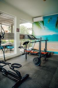 a fitness room with a gym with tread machines at Hotel RH Boutique Aruba in Oranjestad