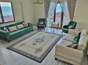 a living room with couches and chairs and a rug at Bahardali Suites - شقق غصن الربيع in Trabzon