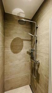a shower with an apple etched on the wall at ApartmentInCopenhagen Apartment 1499 in Copenhagen