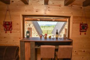 a dining room with a table and a window at Big bear villas in Žabljak