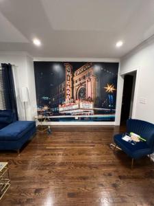 a living room with a large painting on the wall at The Blue Golden Luxury Modern 3- Bedroom Apartment in Chicago in Chicago