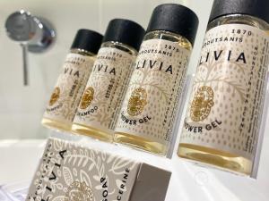 three bottles of olive oil sitting on a shelf at Armata Boutique Hotel in Spetses