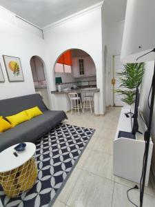 a living room with a couch and a table at APARTAMENTO PLAYA ALCARAVANERAS in Las Palmas de Gran Canaria