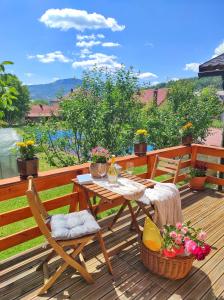 a wooden deck with a table and chairs on it at Monte Chalet Kolašin in Kolašin