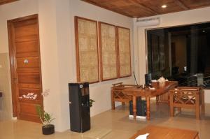 a living room with a table and a refrigerator at Crystal Beach Bali in Candidasa