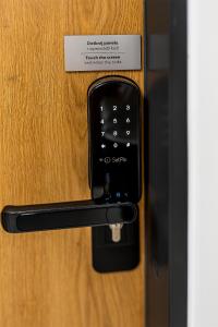 a black door handle with a sign on it at Feel At Home in Wrocław