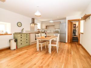 a kitchen with a table and chairs in it at 49 Crovie Village in Gardenstown