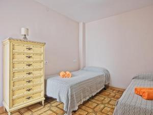 a bedroom with a dresser and two twin beds at CASA EN LA PLAYA VALENCIA EL PERELLO in Mareny Barraquetas