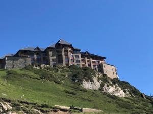 a large building on top of a hill at Vue panoramique - 4pers - parking in La Mongie