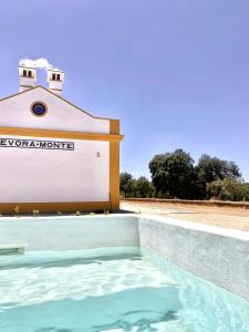 a swimming pool in front of a building at Casas do Apeadeiro in Vimieiro