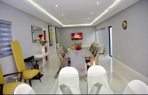 a dining room with a table and chairs at Olive Boutique in Johannesburg