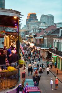 een menigte mensen die door een drukke straat lopen bij Bourbon Orleans Hotel in New Orleans