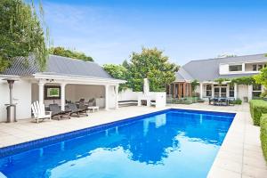 a swimming pool in the backyard of a house at French City Mansion - Christchurch Luxury Home in Christchurch