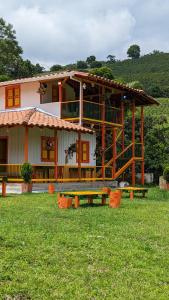 ein Haus mit einem Picknicktisch davor in der Unterkunft Hospedaje Campestre El Rancho de Jero in Jardin