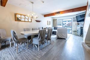 a dining room and living room with a table and chairs at TELEMARK 5 condo in Jeffersonville