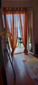 a view of a room with an open door to a patio at Apartmani Kunjasic in Trstenik