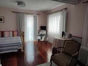 Ένα ή περισσότερα κρεβάτια σε δωμάτιο στο Casa da Isabelinha